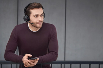 Lifestyle image of the Jabra Evolve2 65 Bluetooth MS Stereo Headset (USB-A), shown in use while listening to music