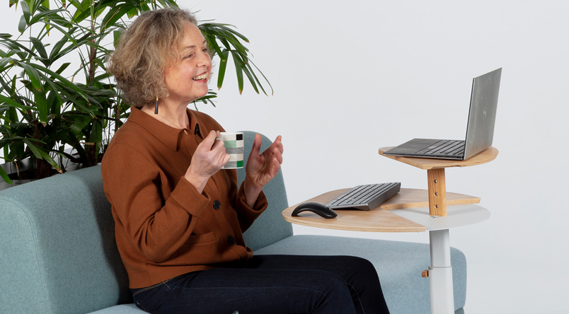 A lady using the Otto Laptop Table during a video call, ensuring a good ergonomic posture