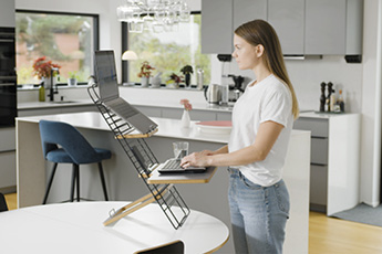 Image showing the Standfriend Sit-Stand Platform being used in a home environment